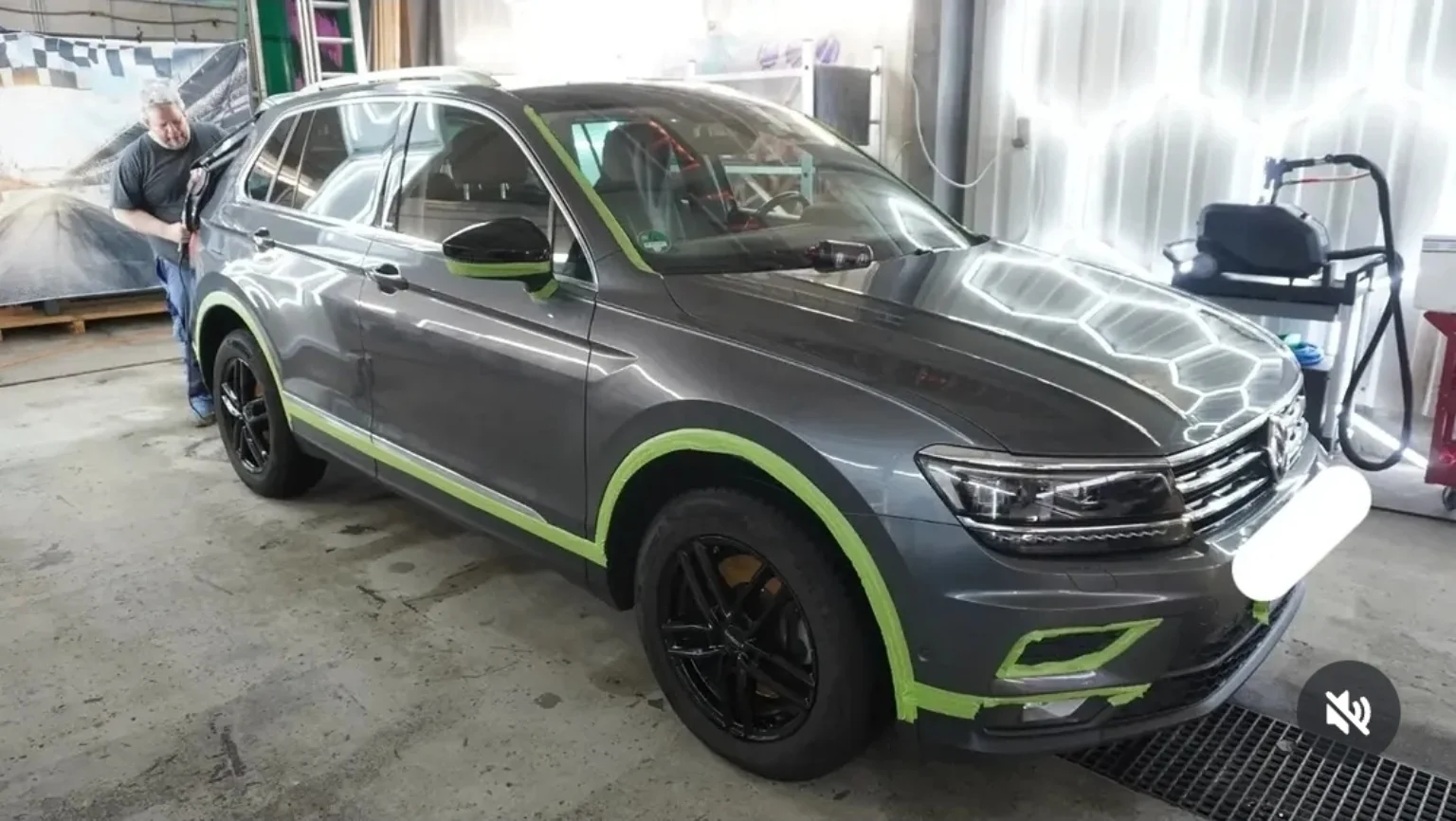Grauer Volkswagen mit abgeklebten Anbauteilen bei der Lackbearbeitung in der Werkstatt von E u. P